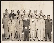 Photograph of men in military uniforms and and civilian clothes posing